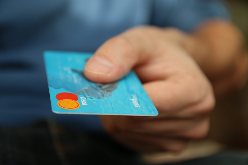 A Credit Card in Light Blue Color in a Hand Image