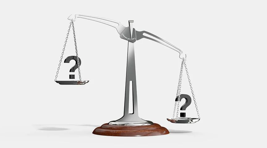 Image of the scales of justice with question marks depicting what are actual damages and how the Schlanger Law Group can help consumers find justice