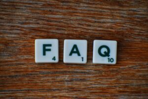 Photo of scrabble tiles spelling FAQ depicting the class action faqs answered by Schlanger Law Group