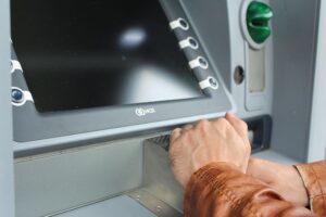 Photo of person covering the ATM keyboard to avoid shoulder surfing which is a situation where Schlanger Law Group can help