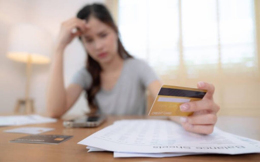 A woman holding a credit card