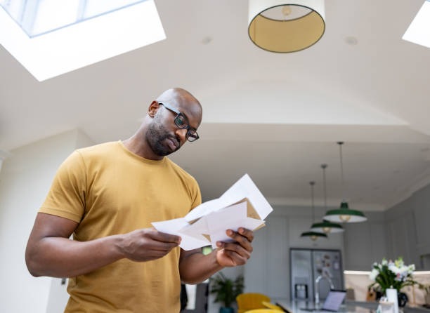 A man reading through a letter