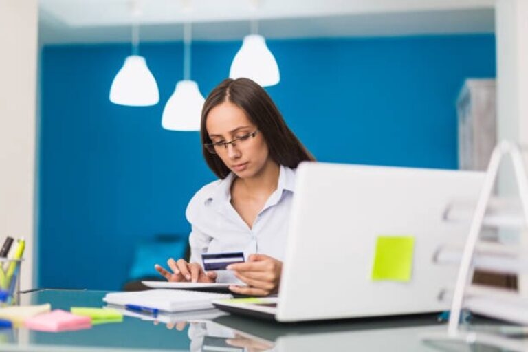 A woman holding a credit card